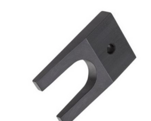 A black metal wedge tool with a curved shape and a hole in one of the arms.